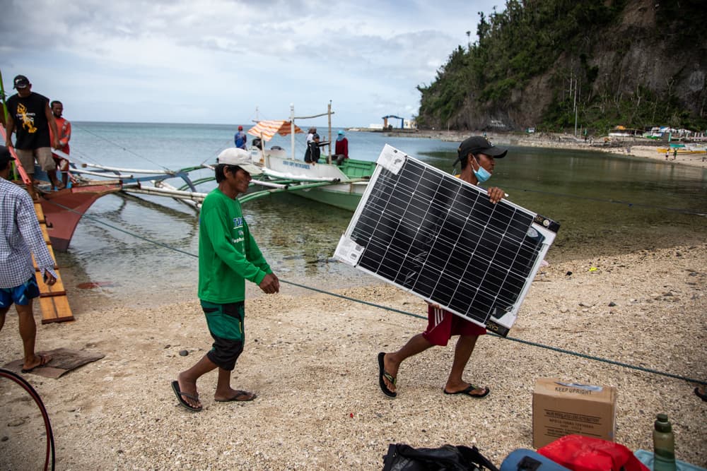 Engineers installing solar panels in a barangay